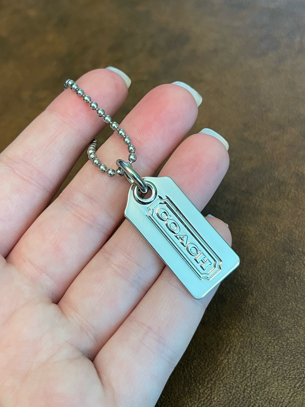 Coach silver metal hangtag